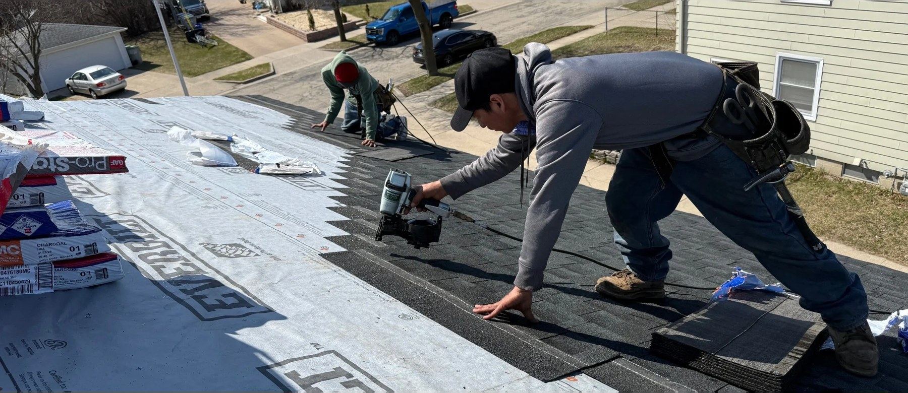 Brew City Roofing crew fastening shingles on a Milwaukee home