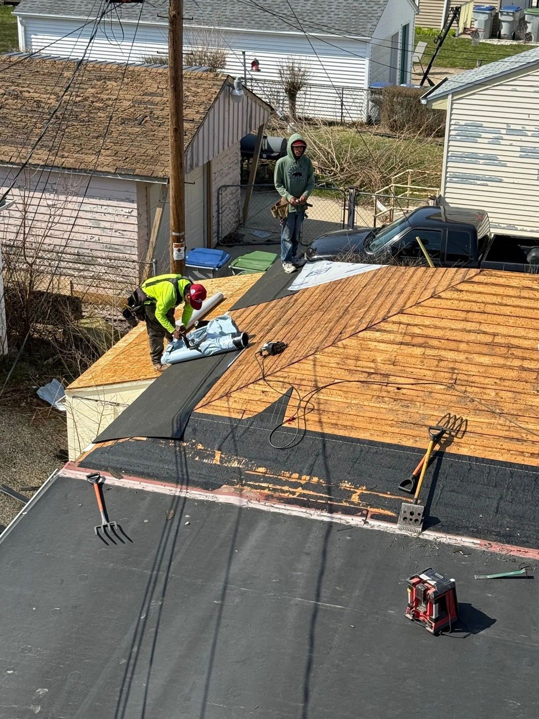Brew City crew installing roof underlayment on an open deck